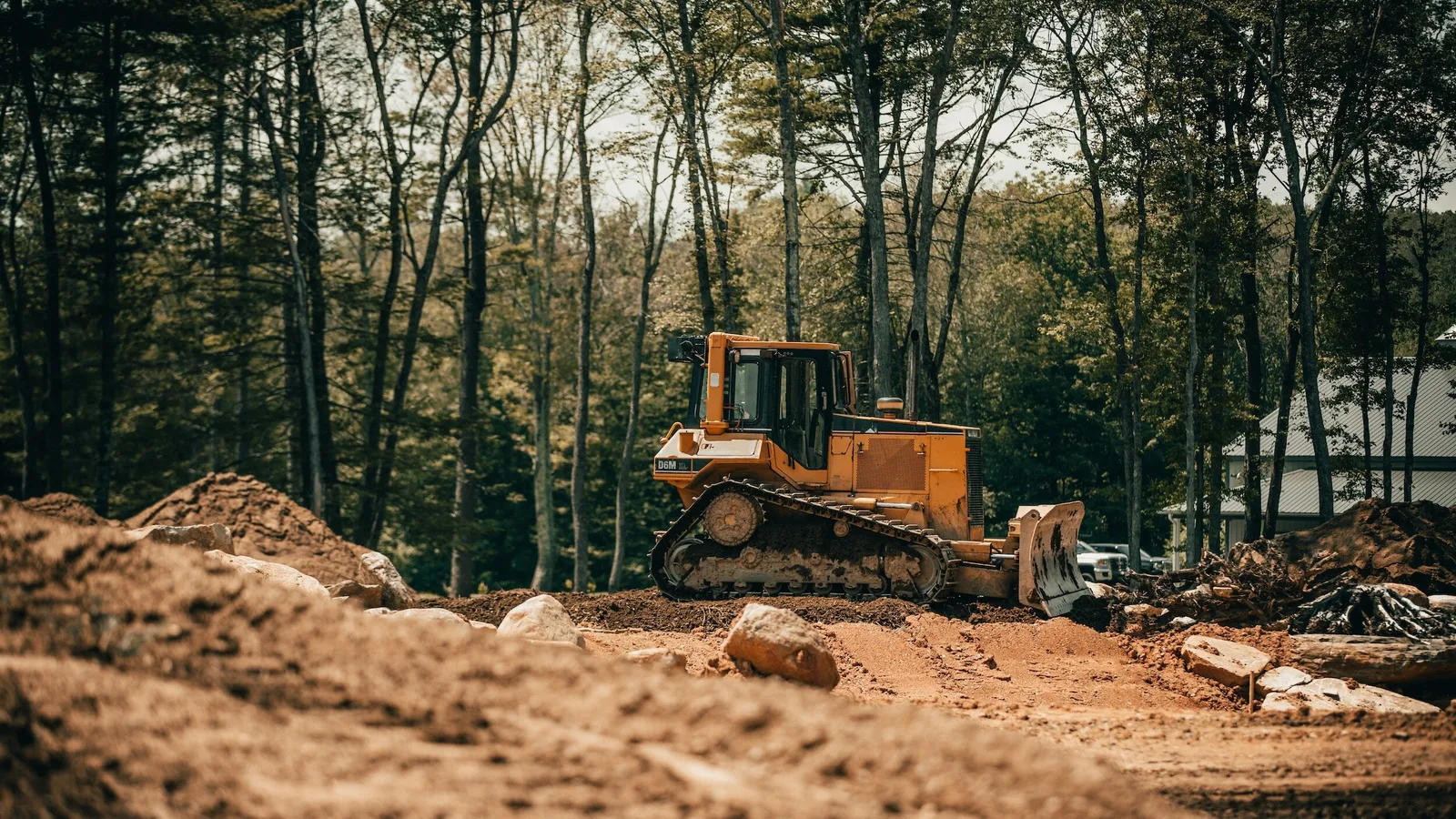 Bulldozer working on a wooded residential property